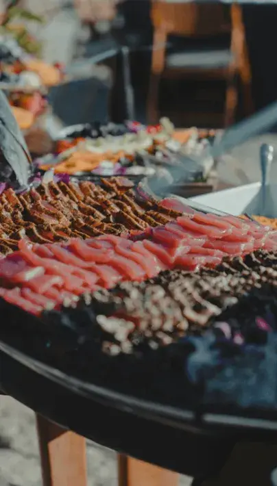 Seared and fresh ahi laid out on a catering table in the sun