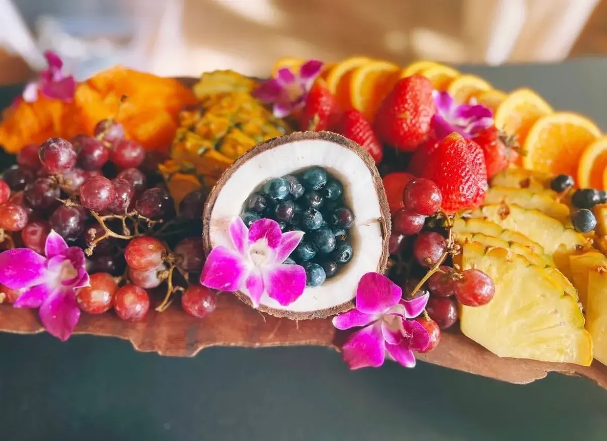Tropical fruit platter with orchids and a halved coconut from Umekes catering