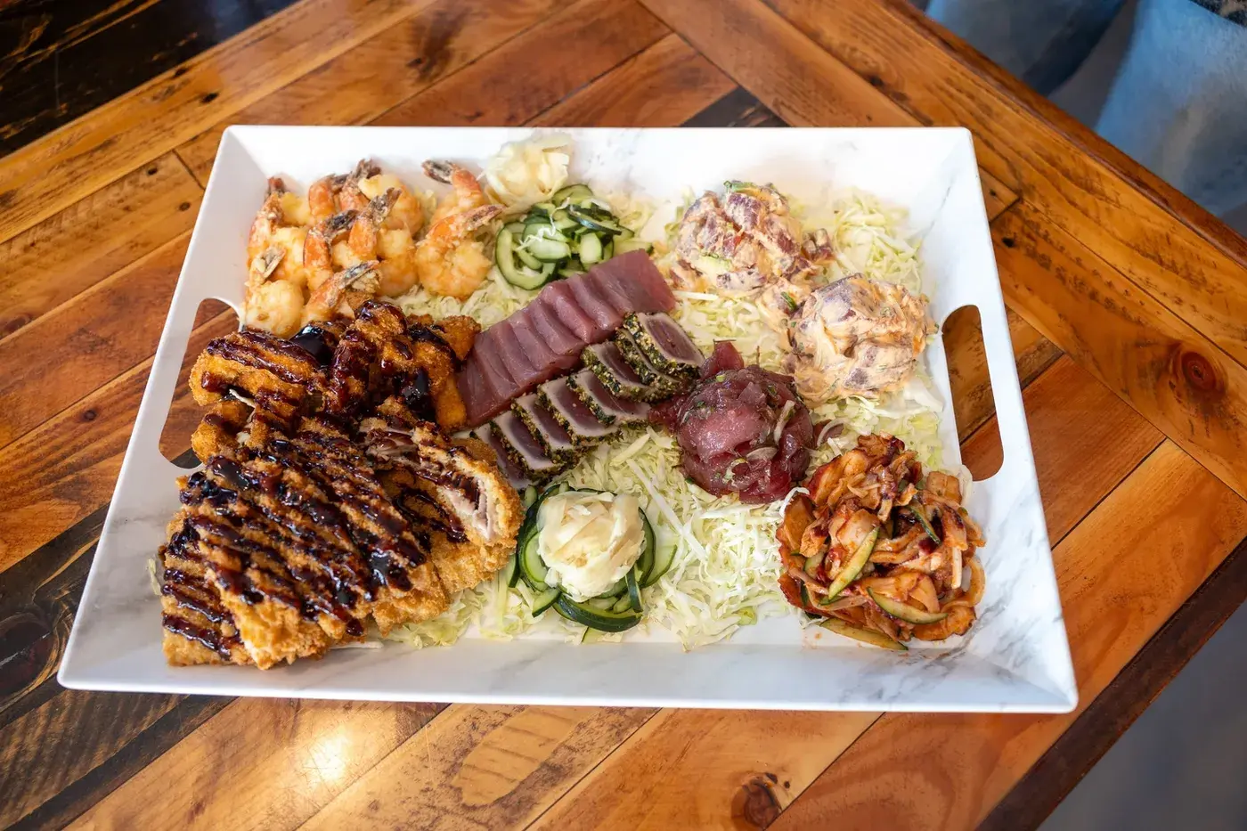 A party platter of seared ahi, katsu, shrimp and poke from Umekes