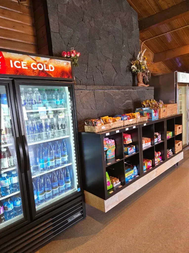 Ice-cold drink coolers and snack shelves at Umekes Saddle Stop
