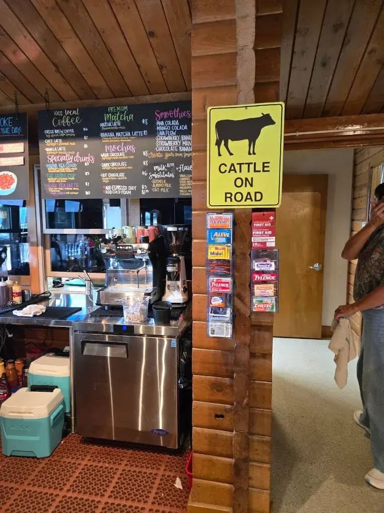 The Umekes Saddle Stop order counter beside a Cattle on Road sign