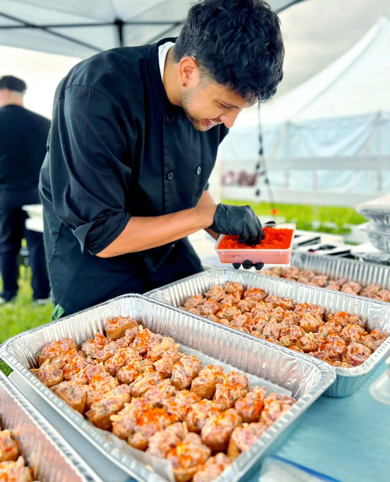 An Umekes chef finishing trays of catering pupus for an event in Kona
