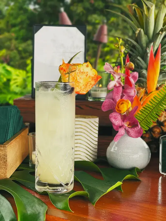 A tropical cocktail beside orchids and pupus at an Umekes party