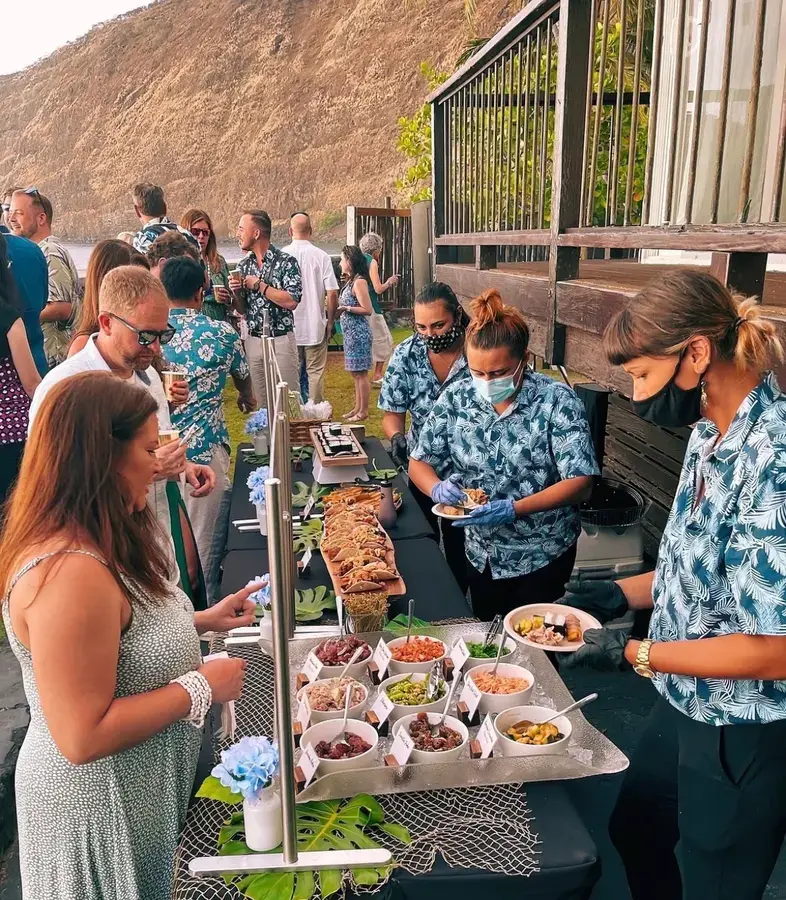 Wedding guests at an Umekes catering buffet on the Kona coast