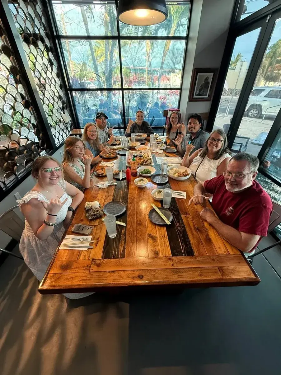 A charter group sitting down to eat their own catch at the Umekes table in Kona