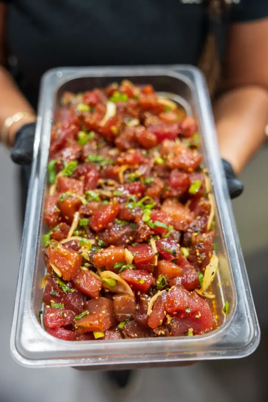 A full tray of fresh cut ahi poke carried out of the Umekes kitchen